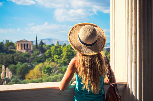 Woman tourist looking at Temple of Hephaestus, Athens in Greece- Ancient Agora