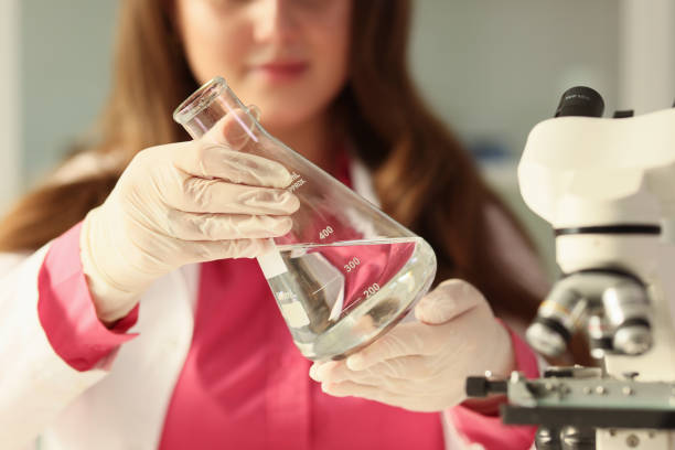 istock Female student holds glass flask with clean water in hands 1775771475