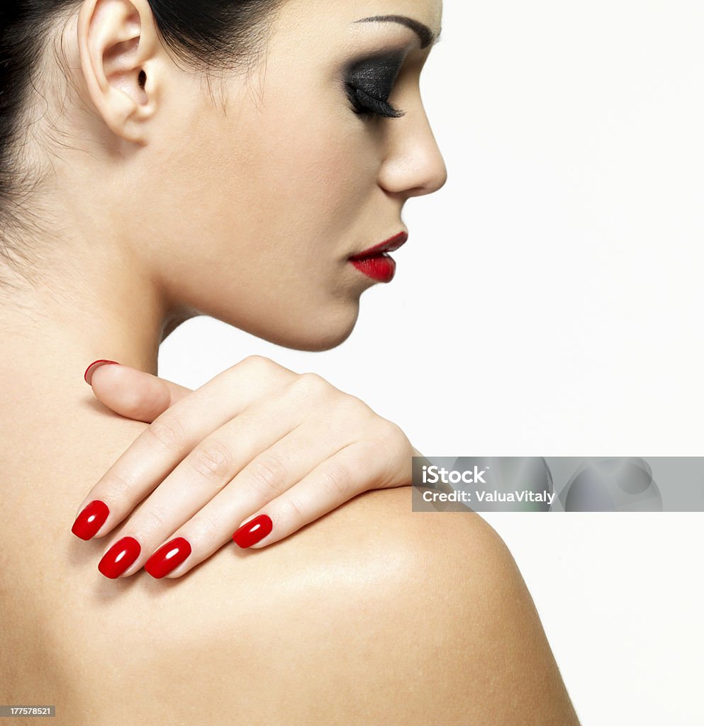 young woman with beauty red  manicure Profile portrait of young woman with beauty red  manicure isolated on white background Adult Stock Photo