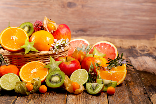 Different citrus fruit on wood background