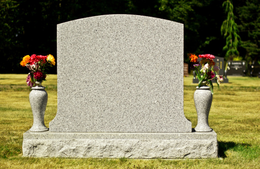 Blank gravestone with other graves in the backgroun
