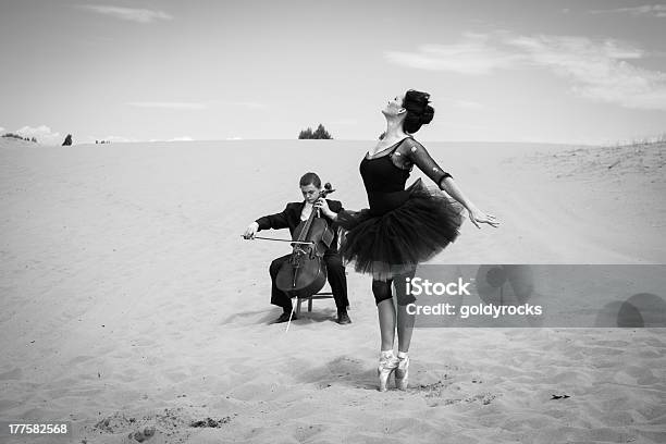 Cultural Encounter In The Desert Stock Photo - Download Image Now - Dancing, Cello, Black And White