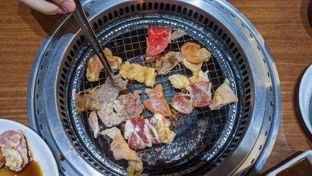 istock grilling meat or yakiniku view at restaurant . 1775837286