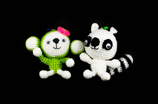 istock handmade crochet monkey and Raccoon doll on black background 177584646