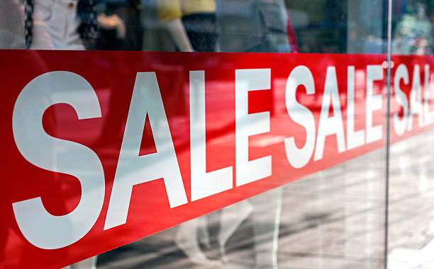 Sale Picture of shop window display with text Sale on red poster reduction stock pictures, royalty-free photos & images