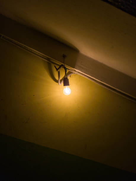 istock Tungsten bulb in old dark basement on the wall. 1775860541