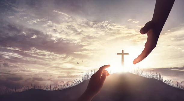 istock redemption concept, God's helping hand and cross on sunset background 1775863479