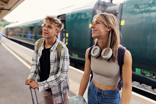Teenagers arriving to Bath, Somerset by train. They are standing on the platform with the suitcases.\nShot with Canon R5