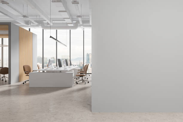 istock Stylish white office interior with pc computers and chairs, mock up wall 1775902940