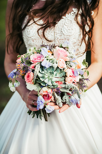 Wedding bouquet of the bride in women's hands. wedding flowers. Bridal bouquet of fresh flowers, wedding concept