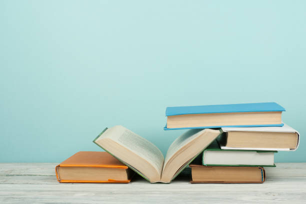 istock Open book, hardback colorful books on wooden table. Back to school. Copy space for text. Education business concept. 1775907974