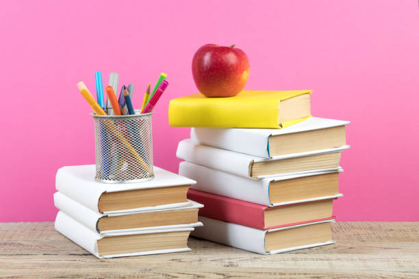 istock Books stacking. Books on wooden table and pink background. Back to school. Copy space for ad text. 1775910169