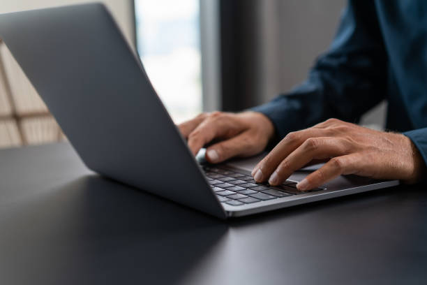 istock Businessman in blue shirt using laptop 1775915639