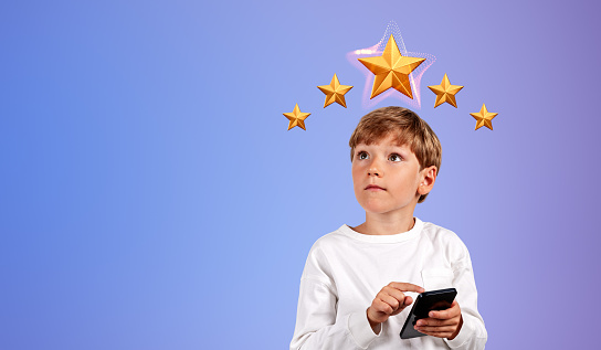 Happy child boy finger touch phone in hand, gradient copy space background. Giving five stars feedback and share positive review online. Concept of customer service and rating
