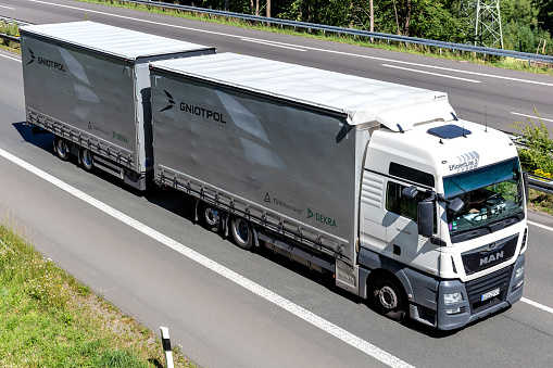 Wiehl, Germany - June 26, 2020: Gniotpol MAN TGX curtainside combination truck on motorway
