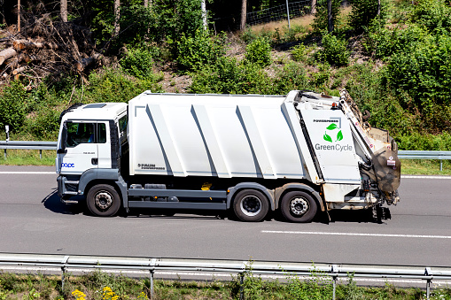 Wiehl, Germany - June 26, 2020: GreenCycle MAN TGS dustcart on motorway