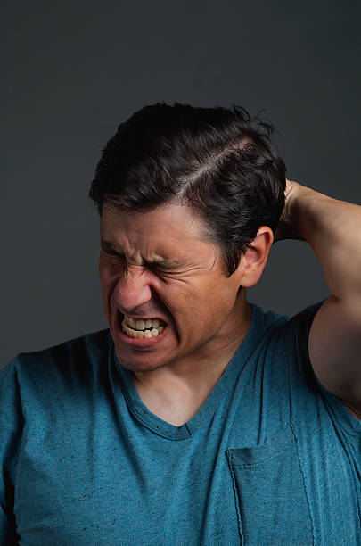Man with eyes Closed and Looking Stressed stock photo