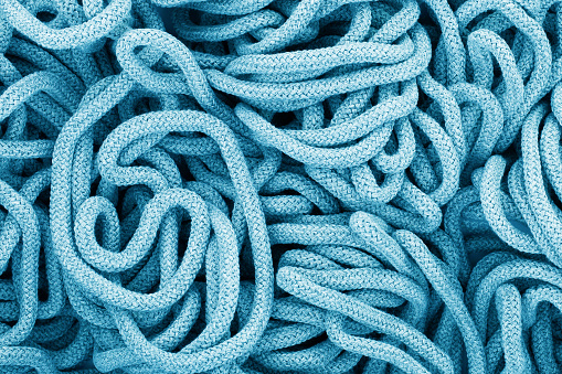 Rope texture. Fabric swirl. Random shape pile of rope. Spiral loop. Abstract textile pattern. Cotton rope background.