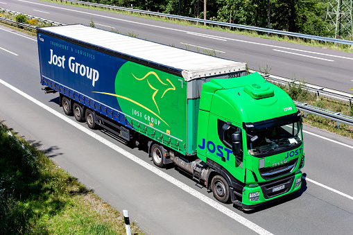 Wiehl, Germany - June 26, 2020: Jost Iveco Stralis truck with curtainside trailer on motorway