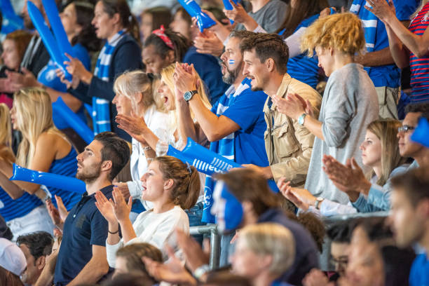 istock Spectators cheering in stadiumSpectators cheering in stadium 1775964327