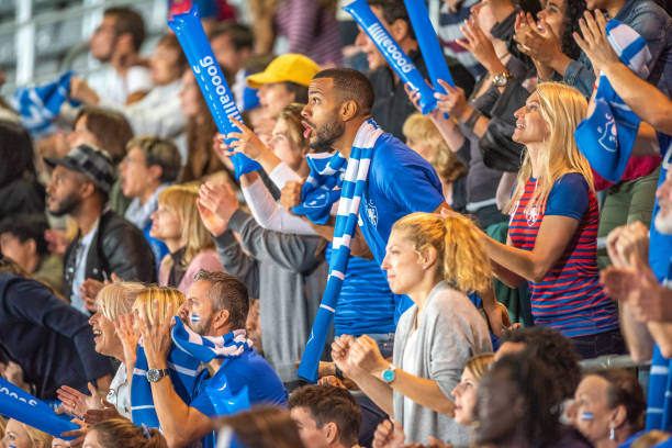 istock Spectators cheering in stadiumSpectators cheering in stadium 1775964328