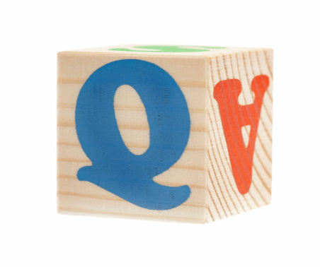 Wooden block with letter Q, isolated on white background