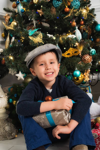 istock Boy under the Christmas tree with gifts. New Year 1775969232
