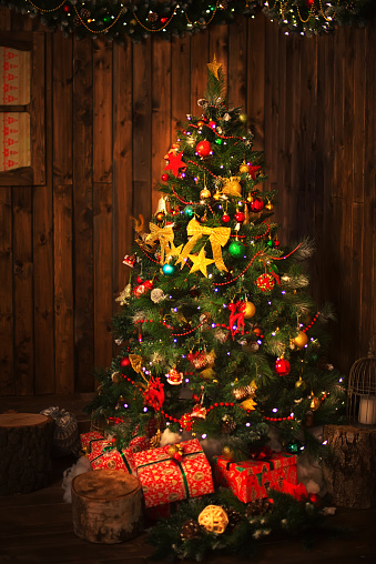 Beautiful Christmas tree with decorations. Gifts under the Christmas tree