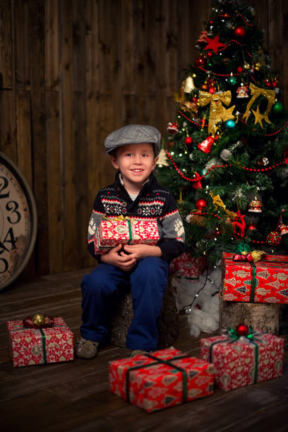 istock Boy under the Christmas tree with gifts. New Year 1775976366