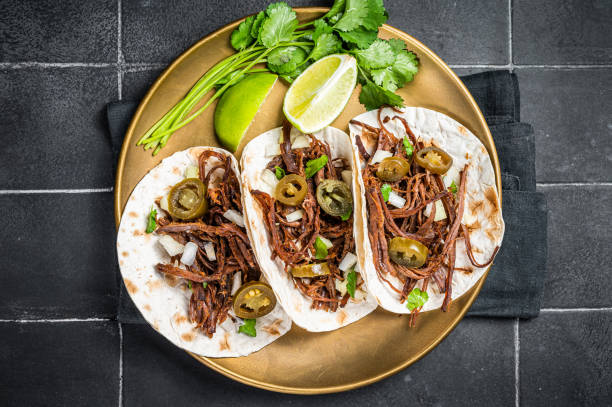 istock Mexican Beef Barbacoa Tacos with Cilantro and Onion. Black background. Top view 1775990812