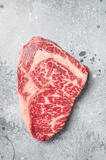 Japanese wagyu rib eye beef meat steak. Gray background. Top view.