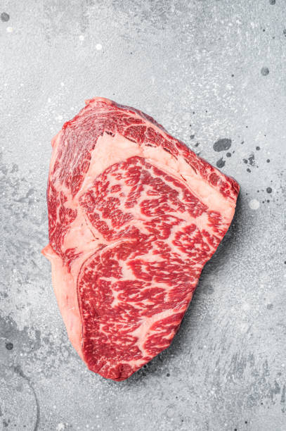 Japanese wagyu rib eye beef meat steak. Gray background. Top view Japanese wagyu rib eye beef meat steak. Gray background. Top view. marbled meat stock pictures, royalty-free photos & images