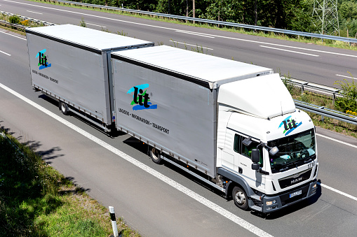 Wiehl, Germany - June 26, 2020: lit MAN TGL curtainside combination truck on motorway
