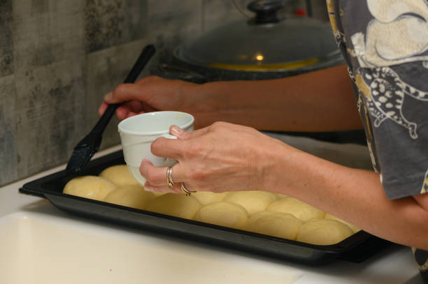 istock woman greases buns in the kitchen 8 1776015055