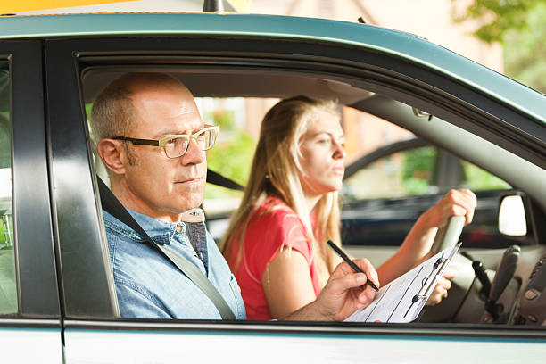 istock Driver Education Instructor and Examiner with Teen in Vehicle 177601682
