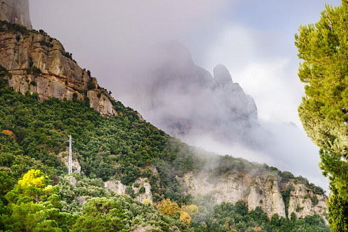 Clouds over Montserrat mountain range near Barcelona, in Catalonia Spain. Rocky landscape. Morning time