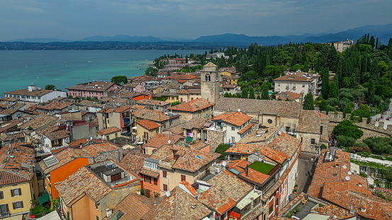 Sirmione is a comune in the province of Brescia, in Lombardy (northern Italy). It is bounded by Desenzano del Garda (Lombardy) and Peschiera del Garda in the province of Verona and the region of Veneto. It has a historical centre which is located on the Sirmio peninsula that divides the lower part of Lake Garda.