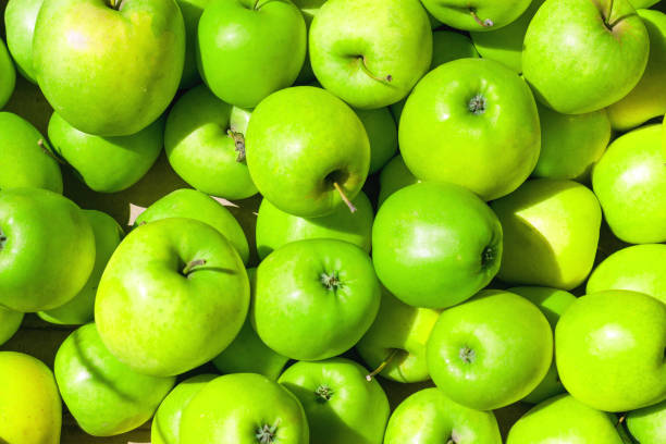 istock Lots of green apples as background, texture, pattern. 1776060216