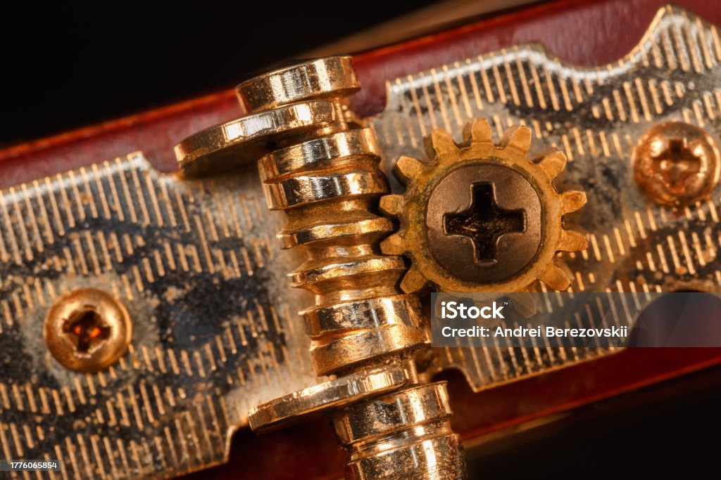 The tuning mechanism of an acoustic guitar. Macro photo Close-up of the tuning mechanism of a classical acoustic guitar. Acoustic Guitar Stock Photo