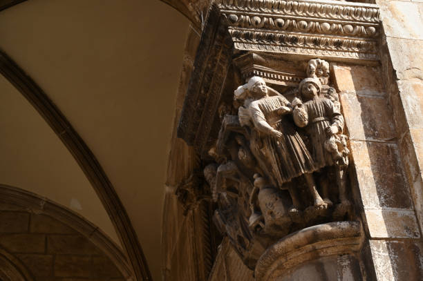 Close-up view of a Corinthian column and ancient stone arch from the historic Diocletian’s Palace in Split, Croatia. Captured on a bright summer day under a clear blue sky, this image highlights Roman architecture and heritage, ideal for use in travel brochures, tourism websites, historical articles, and cultural catalogs. Generous copy space makes it perfect for promotional design layouts.