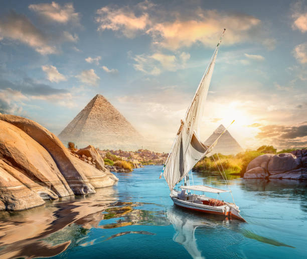 Nile and Aswan and pyramids River Nile and boats at sunset in Aswan and pyramids great pyramid of khufu stock pictures, royalty-free photos & images