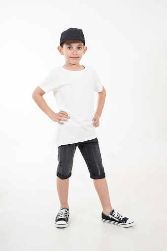 boy with black hat is on white background hands are on his elt vertical fashion still