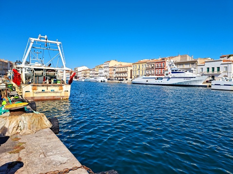 Sète with the Canal Royal (Canal de Sète) and several nautical vessels captured during a sunny day in autumn season.