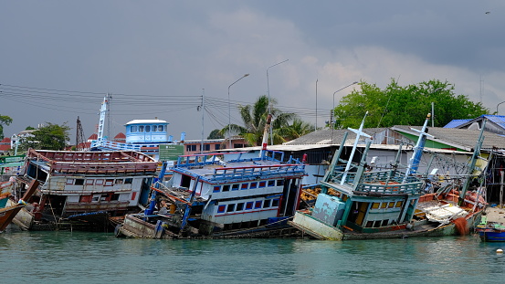 Rayong, Thailand - September, 25 2023 : Old fishing boats wrecked at Ban Phe pier.