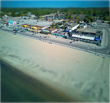 Tilt Shift Lens View of Street and Shops beside a beach