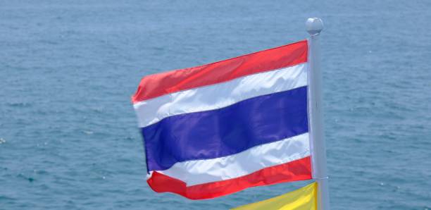 istock Thai flag blowing in the wind with the sea and storm cloud background. 1776146331