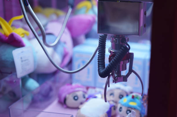 istock Claw Game or cabinet catches the doll.A mechanical arm selecting a random soft toy in a vending machine,selective focus 1776169282