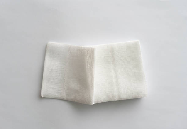 istock pair of foled gauze pads on white background. 1776170412