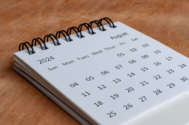 istock August 2024 white table calendar on wooden background. Calendar concept. 1776174221