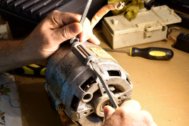 istock An electrician unscrews the bolt holding the engine cover. 1776175303